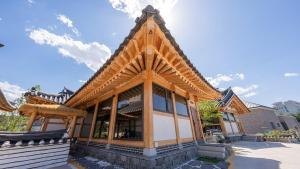 a building with a roof on top of it at Hanok Stay ieum in Gangneung