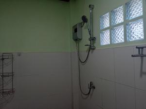 a shower in a bathroom with a window at hadya home in Ko Yao Noi