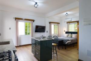 a kitchen and living room with a bed in the background at Green Valley Luxe Apartments in Kingstown