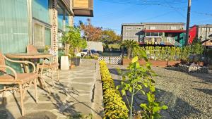 a patio with a table and chairs next to a building at Stay Suncheon in Suncheon