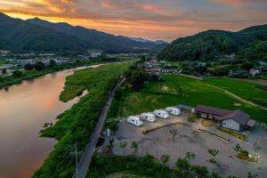 an aerial view of a town next to a river at Gapyeong JY Camping Caravan in Gapyeong