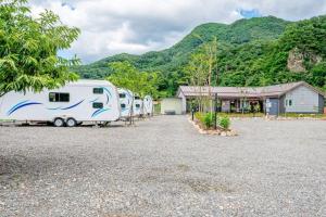 a group of rvs parked in a parking lot at Gapyeong JY Camping Caravan in Gapyeong