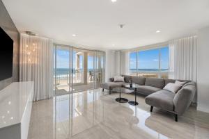 a living room with a couch and a table at La Grande Apartments in Gold Coast