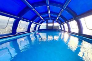 a swimming pool with a blue ceiling and water at Pocheon Choice Camp Caravan in Pocheon