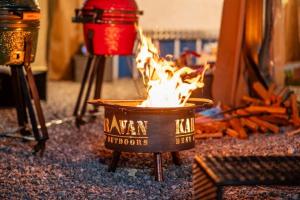a pot of fire on the floor next to carrots at Pocheon Choice Camp Caravan in Pocheon