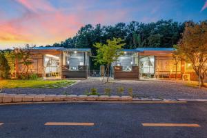 a house with a lot of windows on a street at Pocheon Choice Camp Caravan in Pocheon