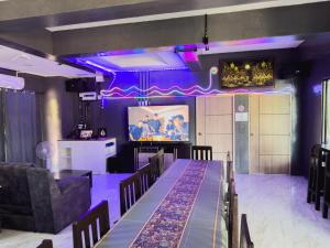 a dining room with a stage and purple lighting at NJ HOME Pool Villa in Ban Phe
