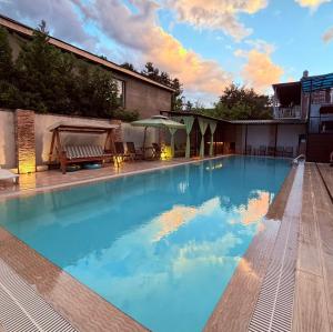 a large swimming pool with blue water at Kaya Telavi in Telavi