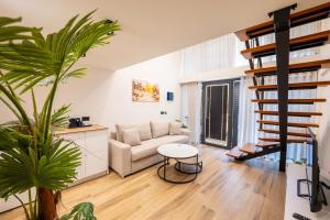 a living room with a couch and a table at Hotel&Apartaments -Villa Hasani 24 in Sarandë