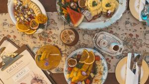 a table with plates of food on a table at LA BURIE HOTEL Chiang Mai in Chiang Mai