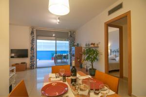 a dining room with a table with wine glasses on it at Hola! - Sitges by the beach in Sitges