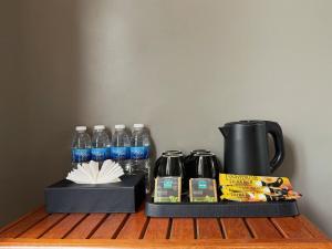 a shelf with a coffee pot and bottles of water at Alicia Resort in Koh Rong Island +45 photos