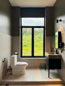 a bathroom with a window and a toilet and a sink at Alicia Resort in Koh Rong Island