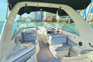 a white boat sitting in the water on the water at One-Bedroom Suite Pool with Bath Kitchen in West Palm Beach in West Palm Beach