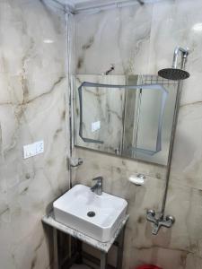 a bathroom with a sink and a mirror at Casa Azul Mountain Resort in Nathia Gali
