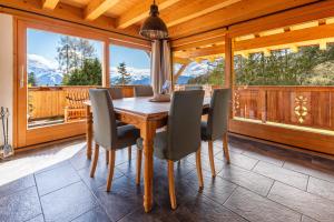 a dining room with a wooden table and chairs at Chalet La Renarde in Villars-sur-Ollon +37 photos