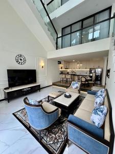 a living room with a couch and a tv at Royal Classic Puncak in Cisarua