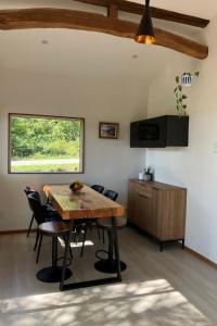 a dining room with a wooden table and chairs at Chalet Tsugaike in Otari