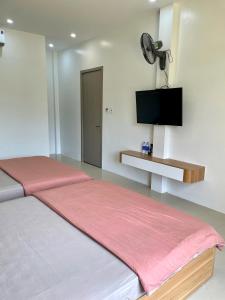 a bedroom with a large bed with a flat screen tv at Tít Mít HomeStay in Cao Bằng