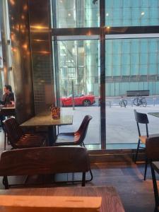 a table and chairs and a red car outside a window at EspirE CleethorpeS in Cleethorpes