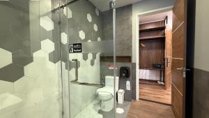 a bathroom with a toilet and a glass door at The RiverKwai Bridge Resort 2 in Ban Chuk Kum +64 photos
