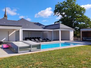 a house with a swimming pool in the yard at Lila in La Chapelle-de-Brain