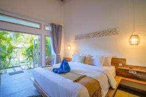 a bedroom with a large bed and a large window at Drift Hideaway- Adult only in Kuta Lombok +41 photos