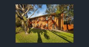 a house with a tree in front of it at Seaside Adelaide Holiday Apartment 2BR 1 min walk to Brighton Beach in Adelaide
