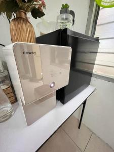 a microwave oven sitting on top of a table at Solehah Homestay in Seri Iskandar