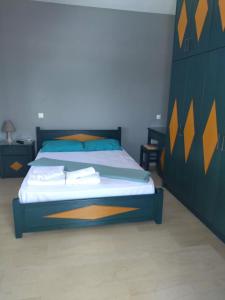a bedroom with a large bed with a wooden headboard at Leonidas Apartments in Preveza