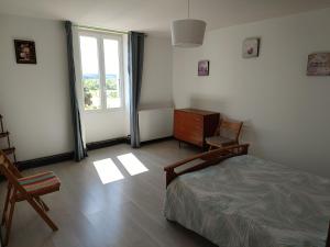 a bedroom with a bed and a dresser and a window at Gîte des deux Moulins en Périgord Vert in Grand Brassac