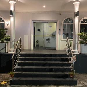 a building with stairs leading to a door at Ipoh Apartment Suites in Ipoh