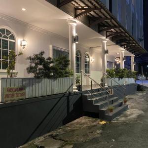 a white building with a staircase on the side of it at Ipoh Apartment Suites in Ipoh