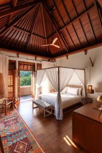 a bedroom with a bed and a couch in a room at La Reserve 1785 Canggu - Adults Only in Canggu +84 photos