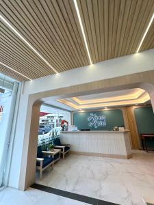 a lobby of a store with a sign on the wall at House Hotel Walking Street Pattaya in Pattaya