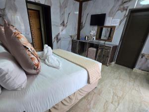 a hotel room with a bed and a stone wall at Europrime Hotels Lakefield in Benoni