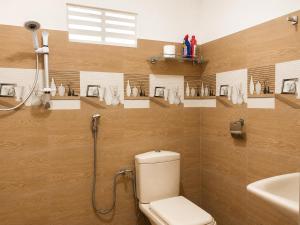 a bathroom with a shower and a toilet and a sink at MG Home Sigiriya in Inamaluwa +4 photos