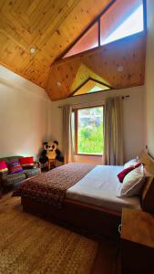 a bedroom with a large bed and a window at Falak Stays in Shamshi