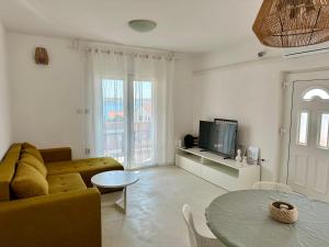 a living room with a couch and a table at PHOS - Pag Residences in Kustići