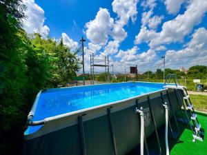 a swimming pool in a yard with a sky at Pensiunea Carmen - Bikers Friendly Nest in Sibiu