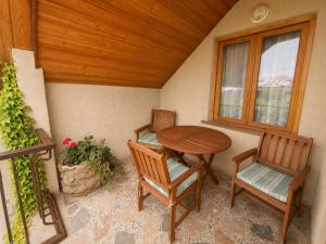 a porch with a table and two chairs and a window at Milorava's Guest House & Wine Cellar in Telavi +33 photos