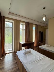 a hotel room with two beds and a piano at Vardzia Hills in Gogasheni