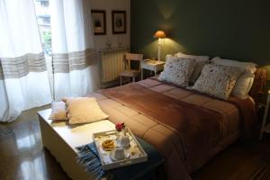 a bedroom with a bed and a table with food on it at A Casa di Amelie in Palermo