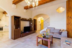 a living room with a couch and a table at Inni Gozitan Farmhouse Private Pool- Happy Rentals in Santu Pietru