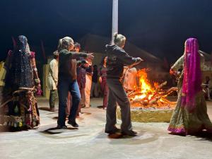 a group of people standing in front of a fire at Rumis Jaisalmer in Jaisalmer