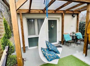 a porch with a hammock on a patio at Balcsitthon Apartmanok in Siófok