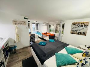a bedroom with a bed and a desk in it at Balcsitthon Apartmanok in Siófok
