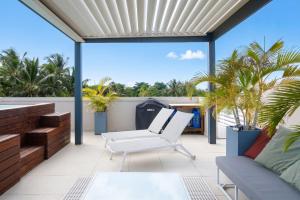 an outdoor patio with a couch and a table at Villa Eden - 2 bedrooms with Private Rooftop Terrace & Pool, Ki Residences, Pereybère - KSN Collection Privée in Grand-Baie