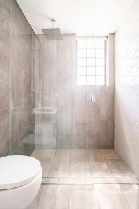 a bathroom with a toilet and a shower at Cozy Bondi Apartment Heated Winter Stay in Sydney +23 photos