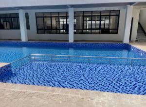 a large swimming pool with blue tiles in a building at JKIA Transit Hub in Syokimau